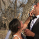 Katie Thurston shoves a large piece of wedding cake into Justin's mouth and sort of up his nose with the force of a rapid Covid test